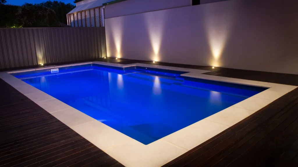 Luxury poolside patio with pergola and lounge chairs