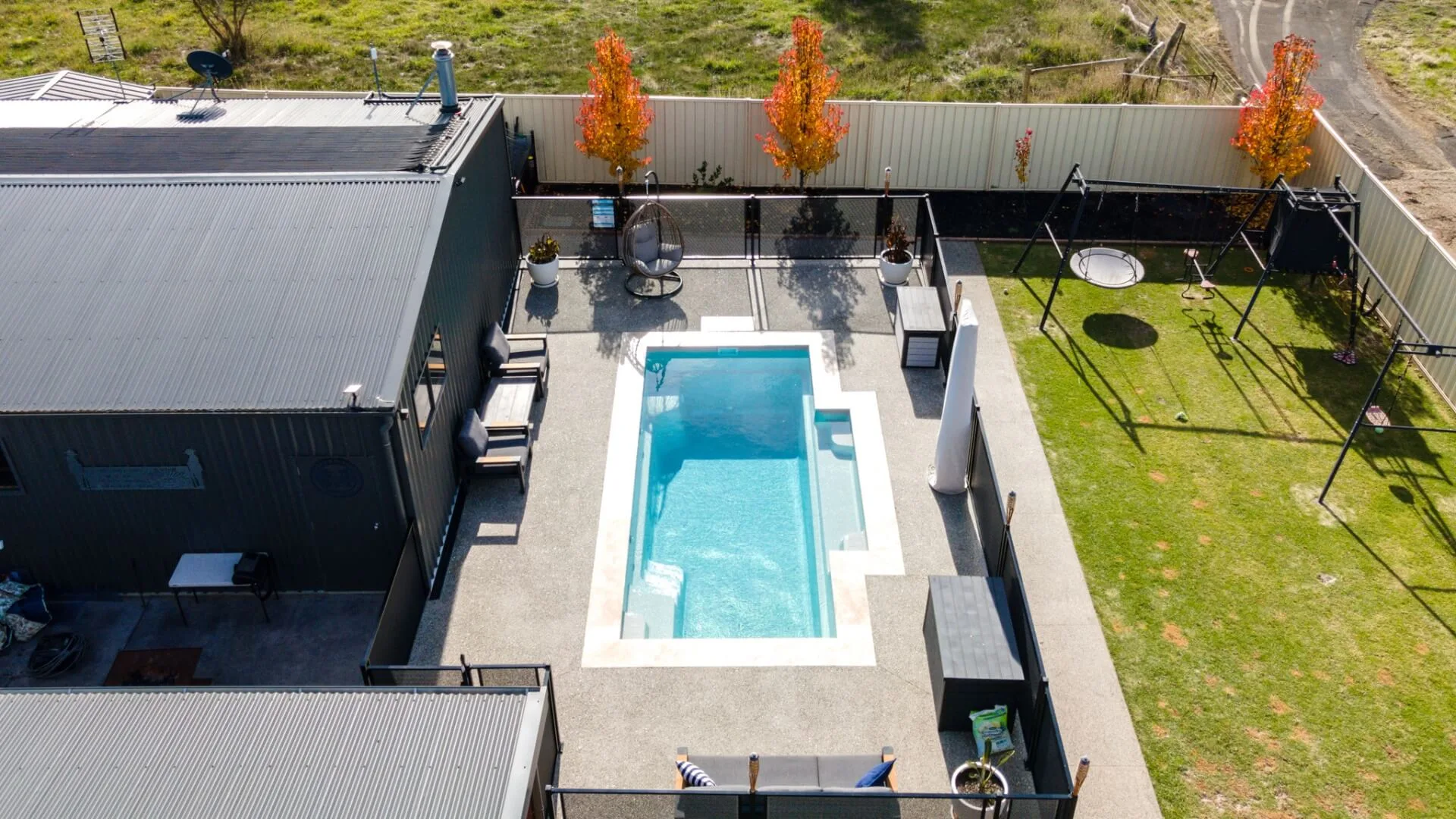 Modern backyard pool with blue LED lighting at night