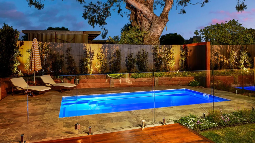 Indoor pool with green lighting and waterfall feature