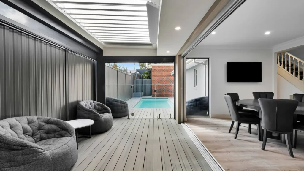 Modern patio lounge opening to pool and dining area
