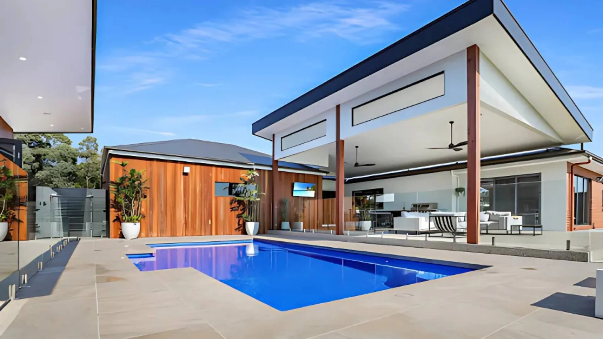 Modern house with clean blue swimming pool and patio area