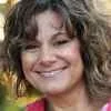 Smiling woman portrait with curly hair in natural light